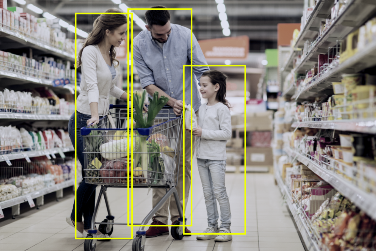 Two adults and a child in a retail store aisle