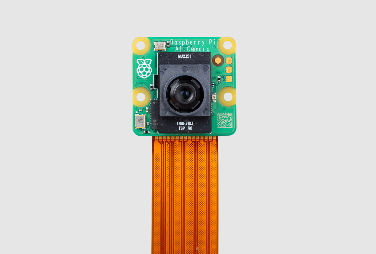 A photograph of the Raspberry Pi AI Camera accessory on a grey background